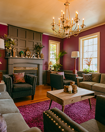 eclectic bed and breakfast living room with purple walls and carpet