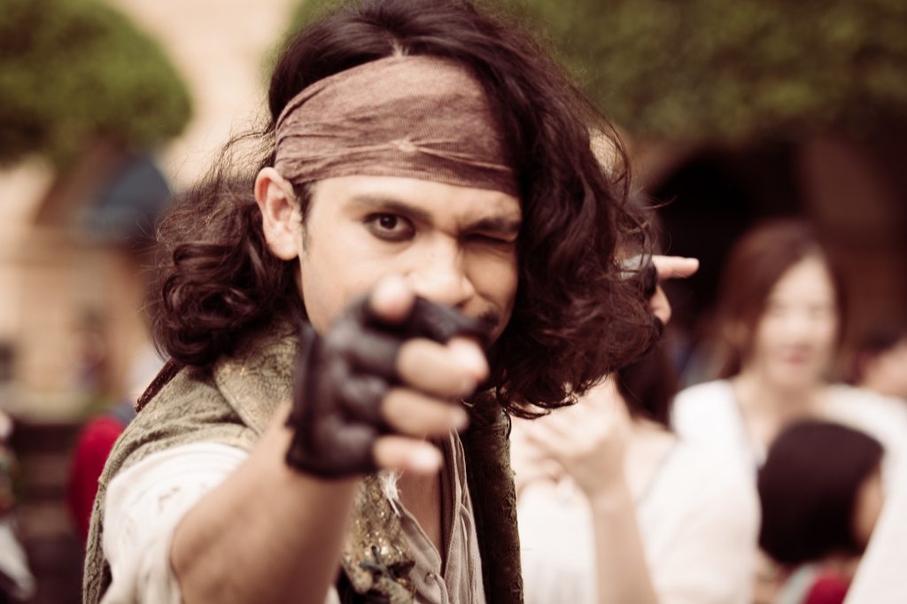 man dressed as pirate pointing at camera