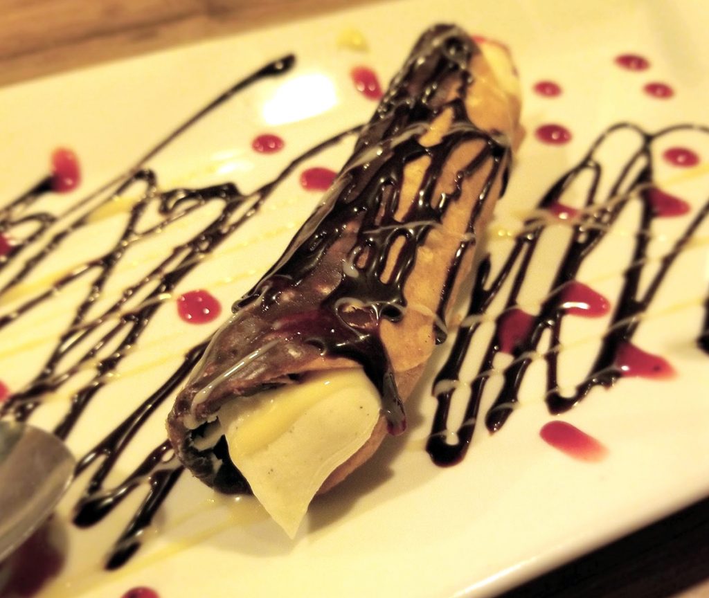 canoli drizzled in chocolate sauce